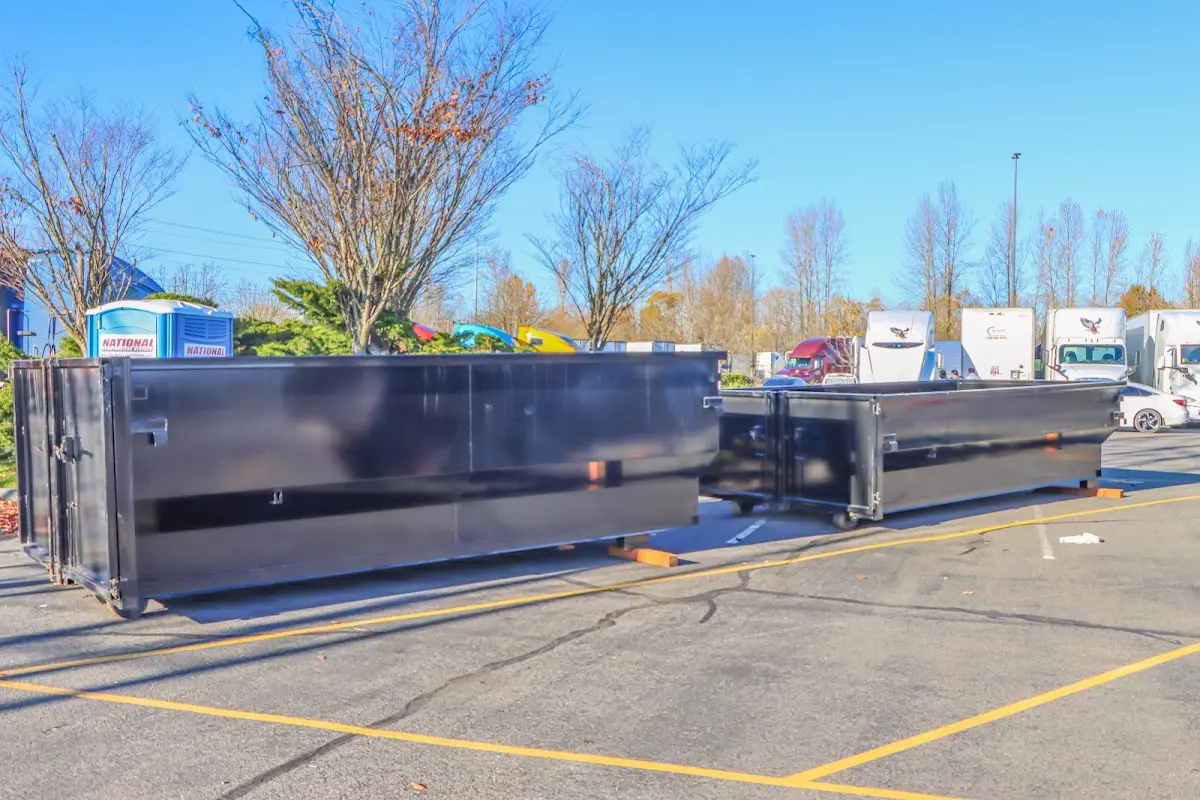 Professional dumpster rental service with roll-off container on residential driveway in Sunset